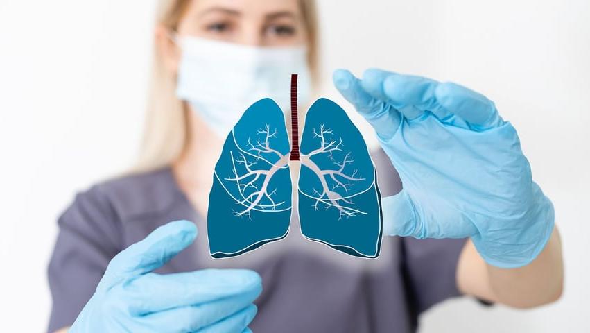 nurse holding lungs symbol